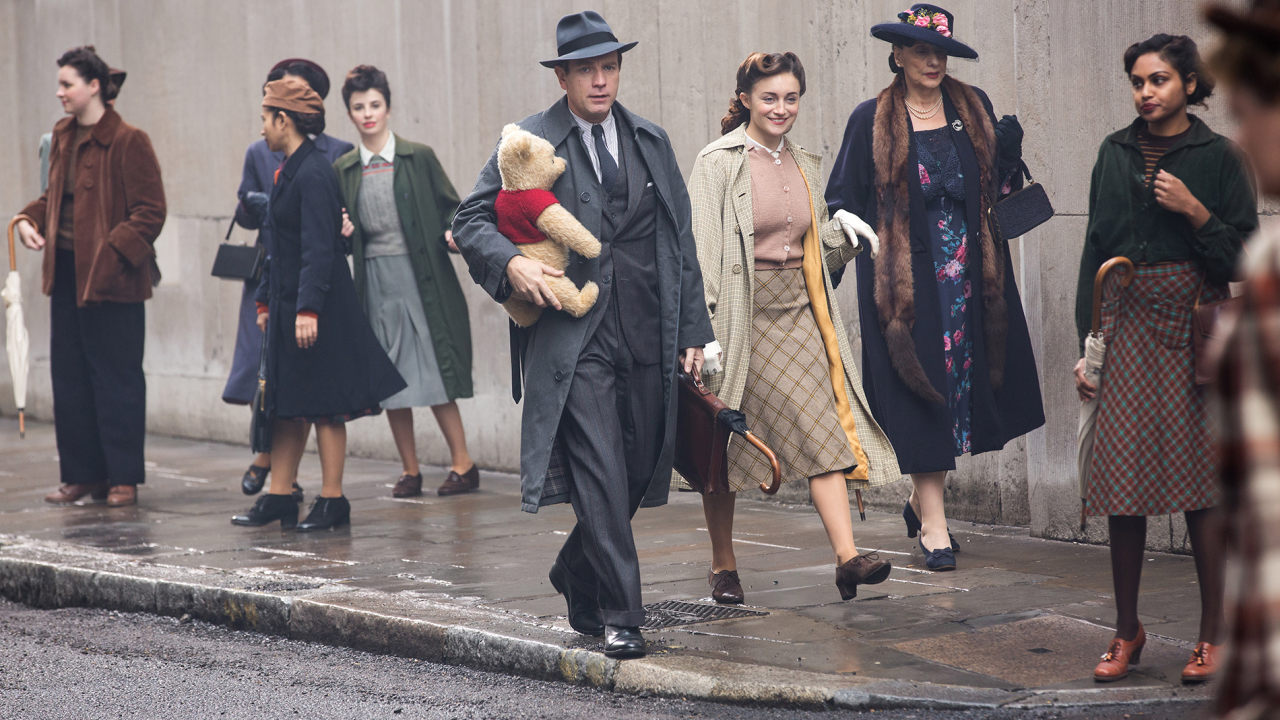 Christopher Robin (Ewan McGregor) and his longtime friend Winnie the Pooh walk down the street in London in Disney’s CHRISTOPHER ROBIN.